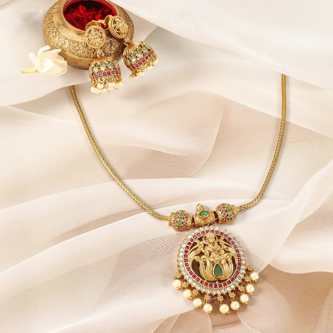 Stunning Gold-Plated Laxmi Temple Necklace Set Adorned with Ruby, Emerald, and Sparkling CZs, Featuring Elegant Pearl Drops